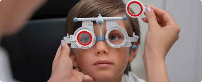 Pediatric eye clinic in Dubai performing a child vision test with trial lenses at Aloka Eye Clinic